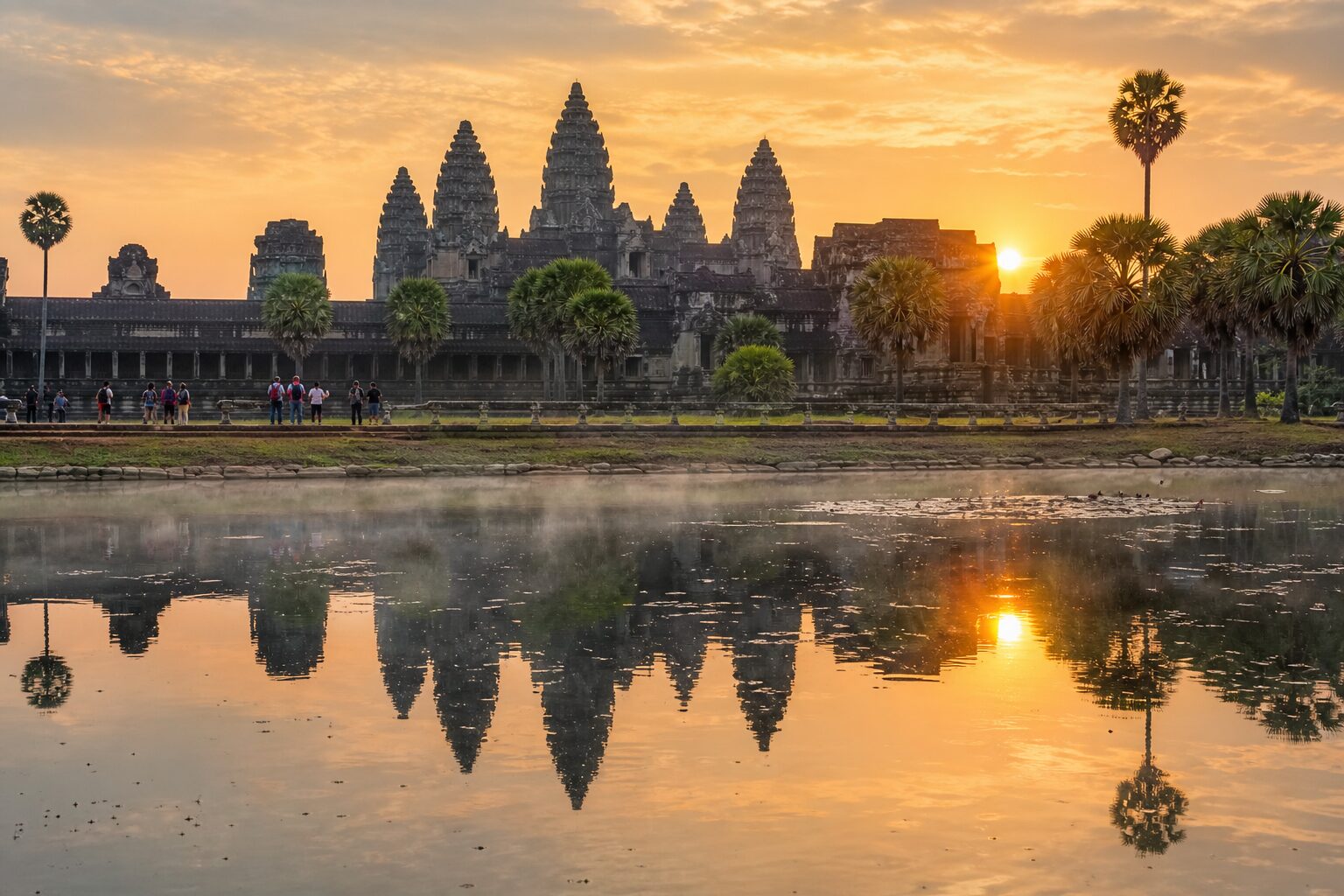 The five stone towers of Angkor Wat in Cambodia reflected in the temple moat at sunrise